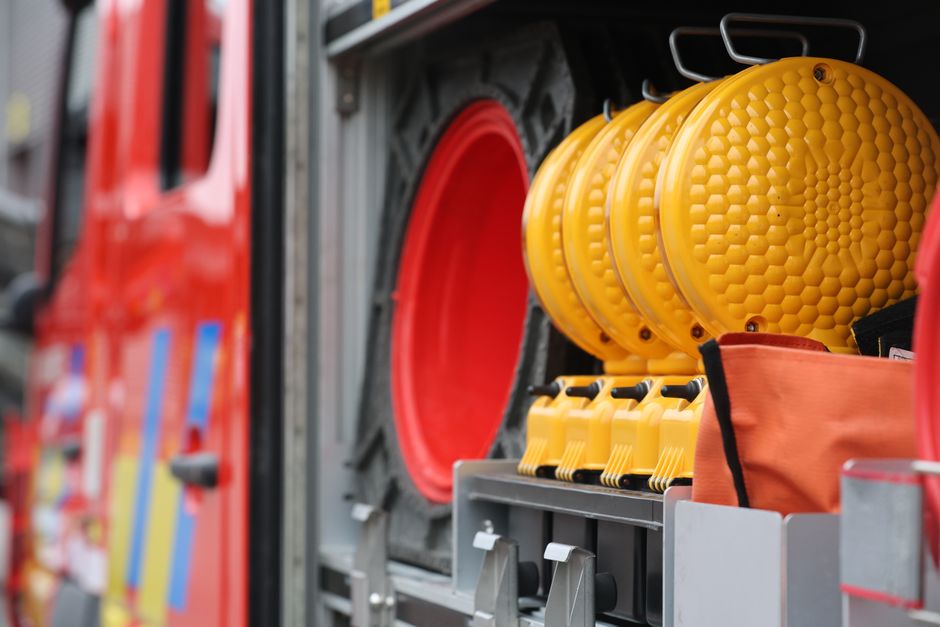 Colorful fire truck storage with safety equipment featuring vivid reds and yellows.