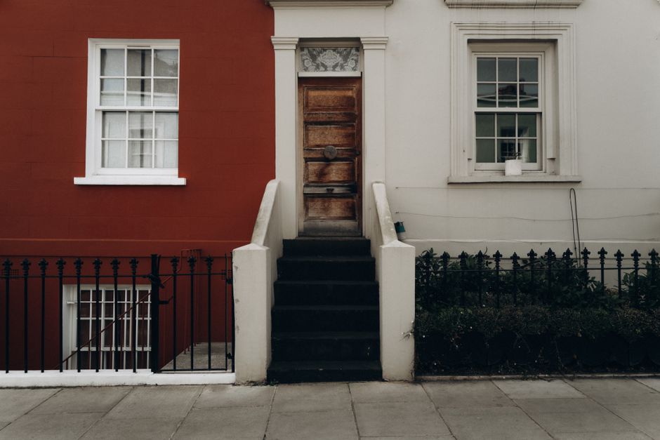 Charming residential facade featuring ornate doorway and steps in Notting Hill, London.